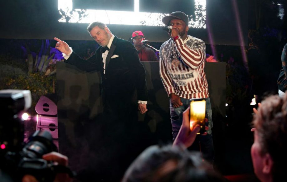 John Travolta Turns Up with 50 Cent on Stage in Cannes